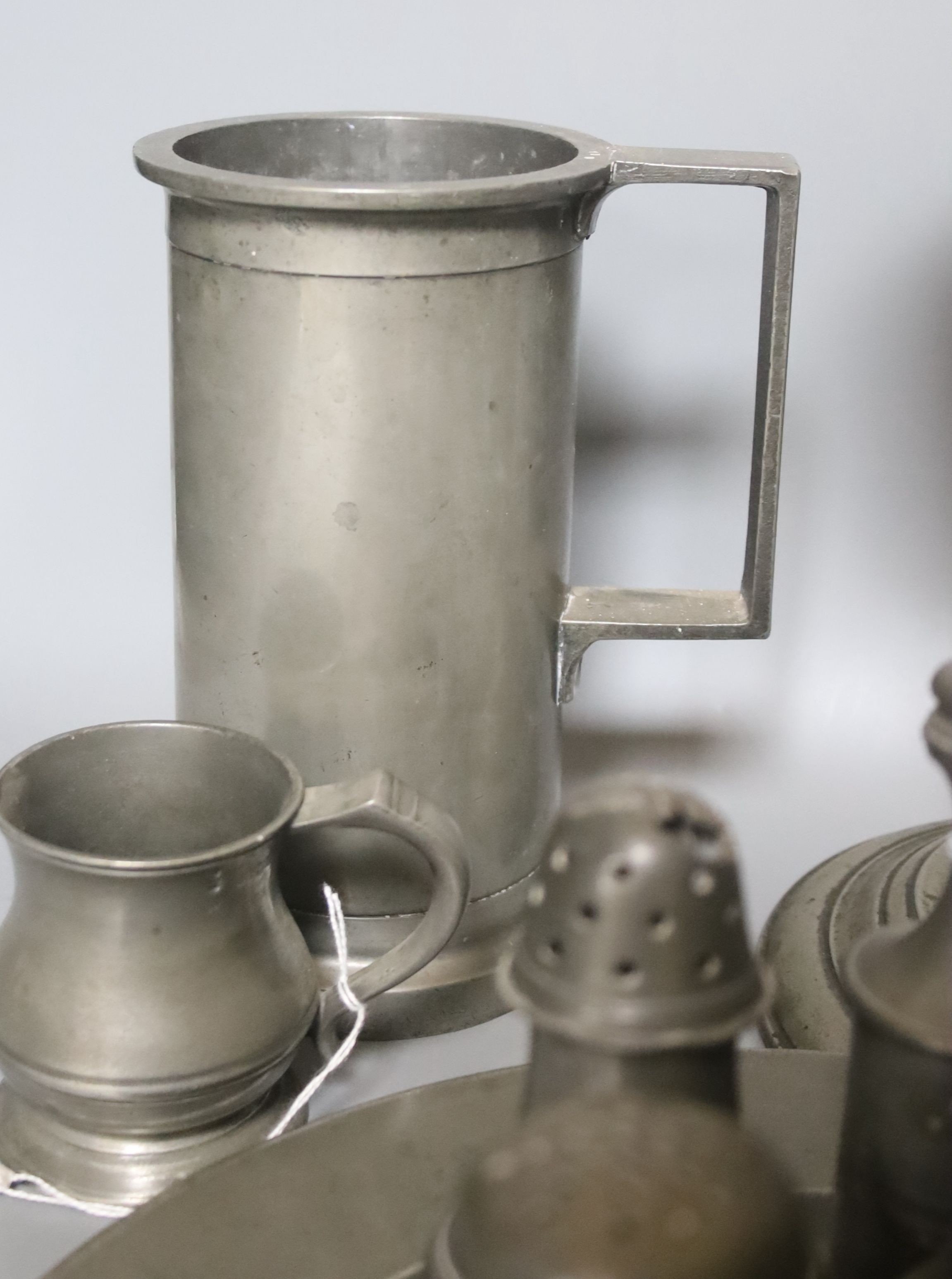 Seven pewter salt or pepper pots, a goblet, 23.5cm, four measures and a plate